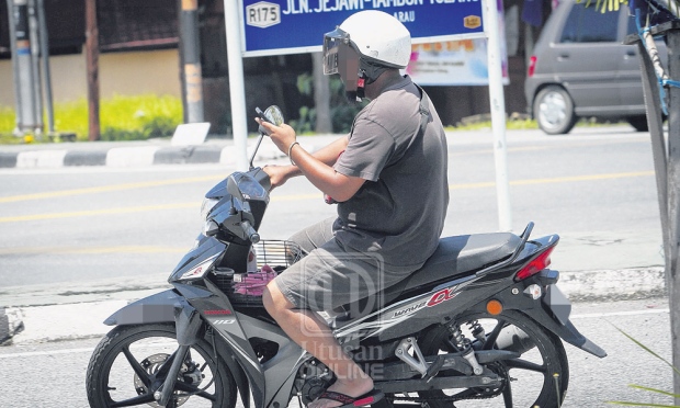 main henfon ketika menunggang motosikal